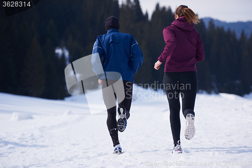 Image of couple jogging outside on snow