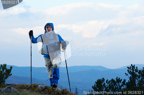 Image of advanture man with backpack hiking