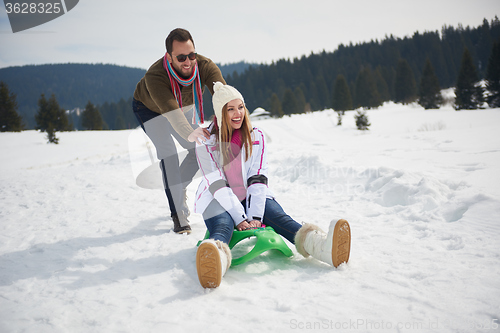 Image of happy young couple having fun on fresh show on winter vacation