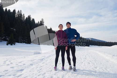 Image of couple jogging outside on snow