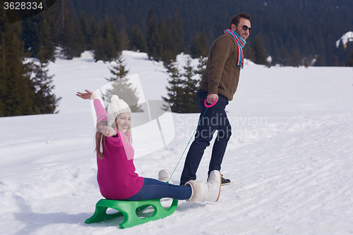 Image of happy young couple having fun on fresh show on winter vacation