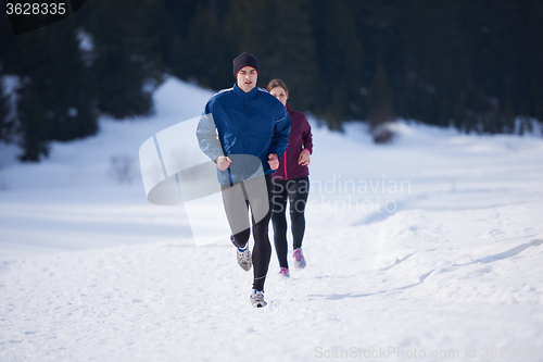 Image of couple jogging outside on snow