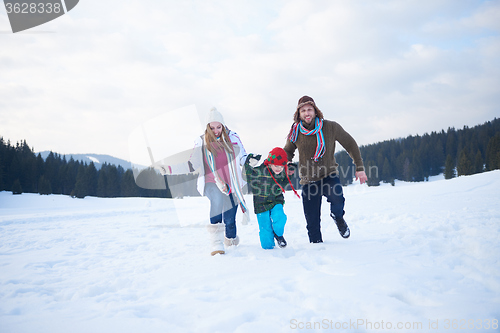 Image of happy family playing together in snow at winter