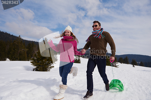 Image of happy young couple having fun on fresh show on winter vacation