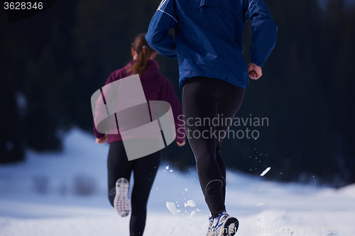 Image of couple jogging outside on snow