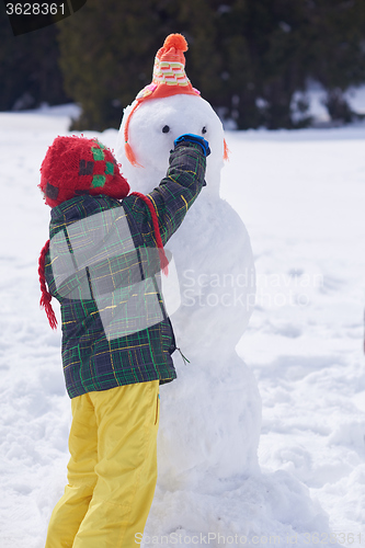 Image of boy making snowman