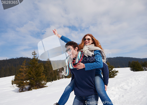 Image of happy young couple having fun on fresh show on winter vacation