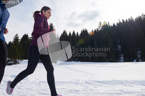 Image of couple jogging outside on snow