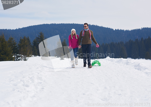 Image of happy young couple having fun on fresh show on winter vacation