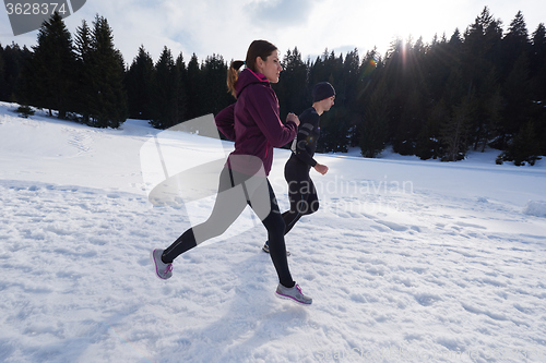 Image of couple jogging outside on snow