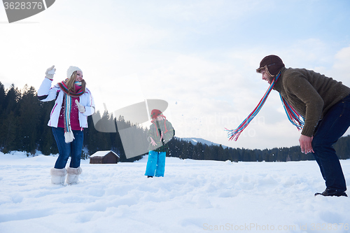 Image of happy family playing together in snow at winter