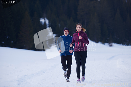 Image of couple jogging outside on snow