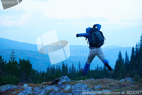 Image of advanture man with backpack hiking