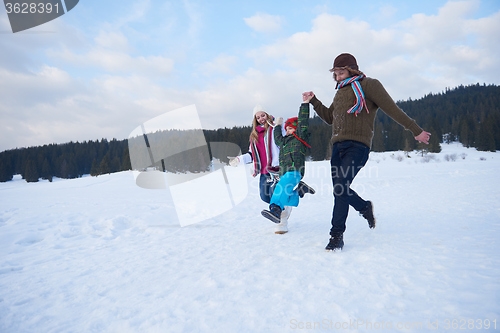 Image of happy family playing together in snow at winter
