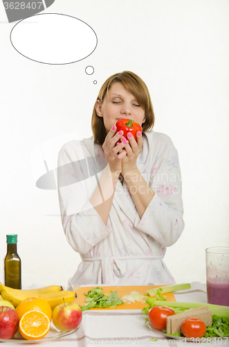 Image of Young girl smelling a vegetarian peppers with thought cloud over his head