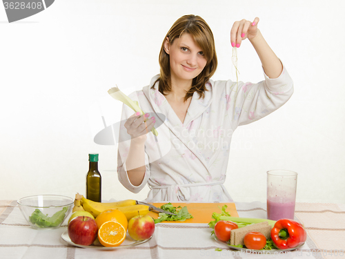 Image of Happy housewife cleared peel the celery prepare salads