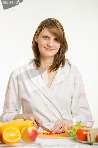 Image of Portrait of a young girl who cuts vegetables for salads