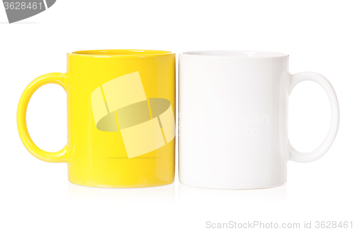 Image of Yellow and white mugs for coffee or tea