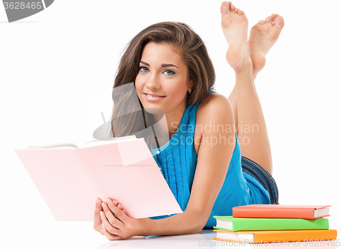 Image of Student girl with books lying on floor