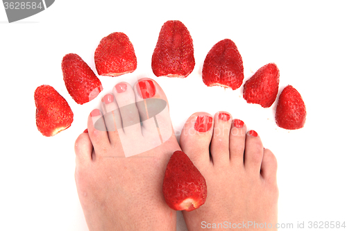 Image of woman feet and strawberries
