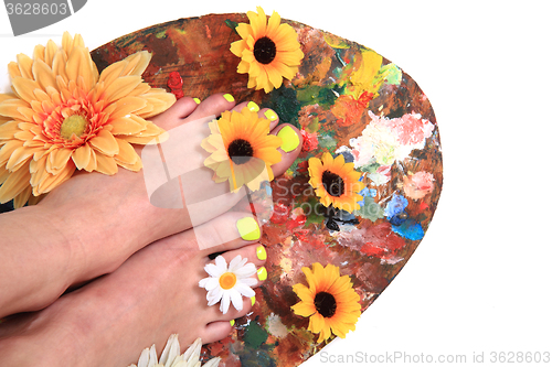 Image of women feets and flowers (pedicure tbackground)