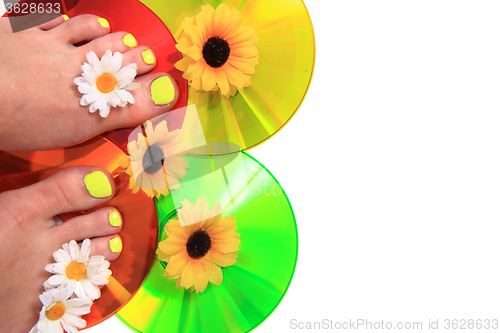 Image of women feets and flowers (pedicure tbackground)