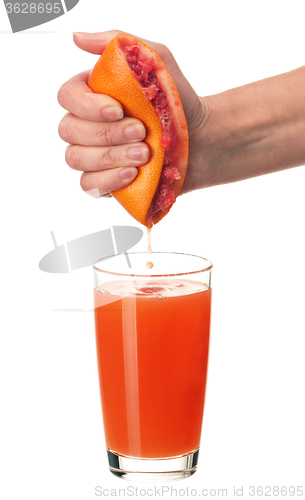 Image of Grapefruit juice and hand