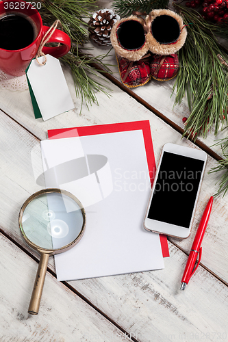 Image of The blank sheet of paper on the wooden table with a pen 