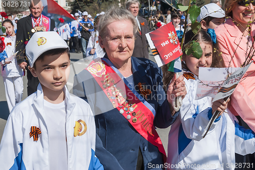 Image of Veterans of sport with children walking on parade