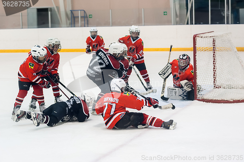 Image of Game near gate. Children ice-hockey