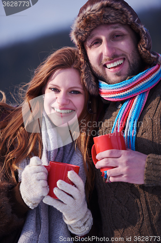 Image of couple drink warm tea at winter