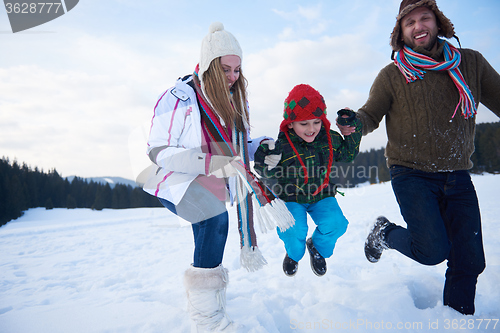 Image of happy family playing together in snow at winter