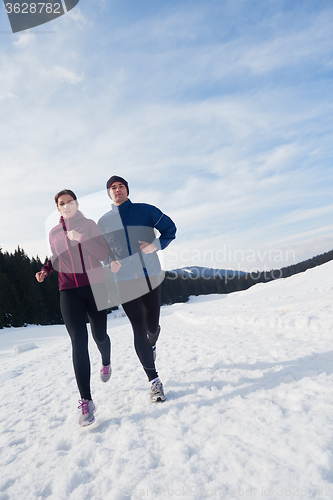 Image of couple jogging outside on snow