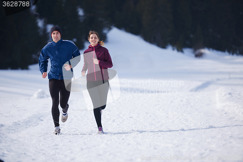 Image of couple jogging outside on snow