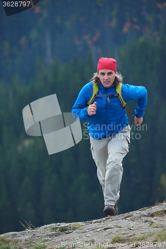 Image of advanture man with backpack hiking