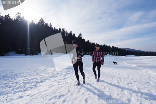 Image of couple jogging outside on snow