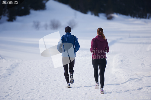 Image of couple jogging outside on snow