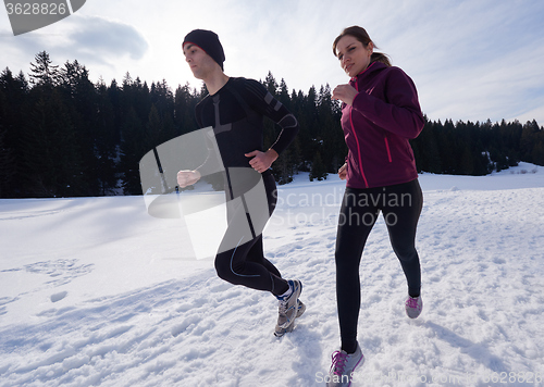 Image of couple jogging outside on snow