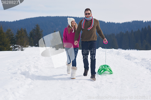 Image of happy young couple having fun on fresh show on winter vacation