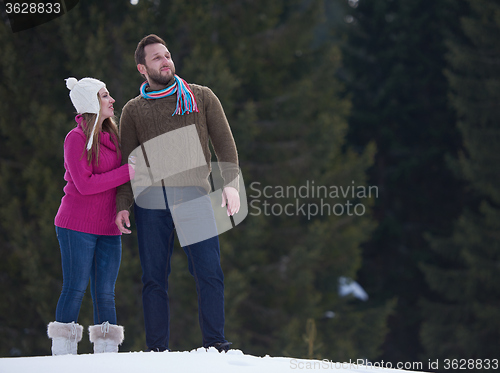 Image of couple having fun and walking in snow shoes