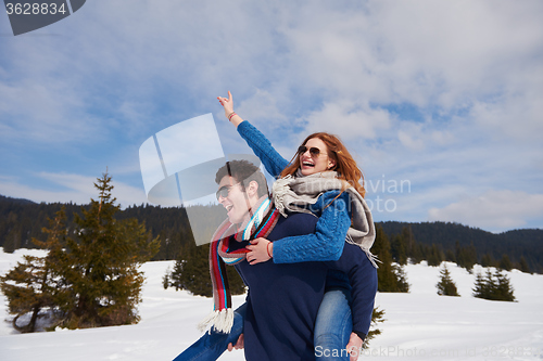 Image of happy young couple having fun on fresh show on winter vacation