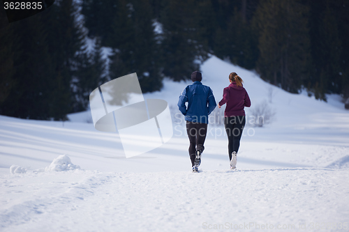 Image of couple jogging outside on snow