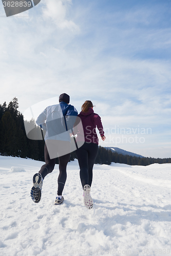 Image of couple jogging outside on snow