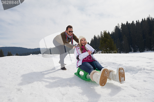 Image of happy young couple having fun on fresh show on winter vacation