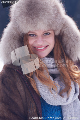 Image of portrait of beautiful young redhair woman in snow scenery