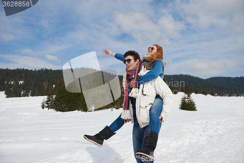 Image of happy young couple having fun on fresh show on winter vacation