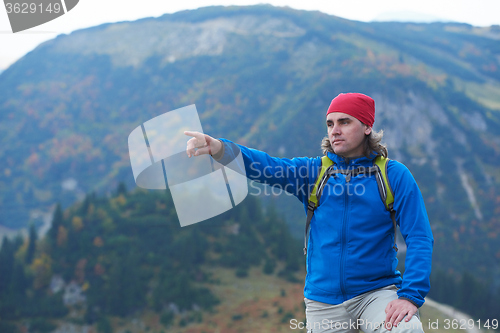 Image of advanture man with backpack hiking