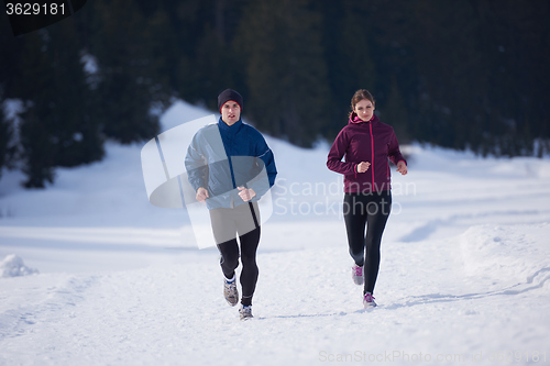 Image of couple jogging outside on snow