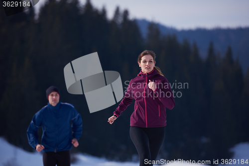 Image of couple jogging outside on snow