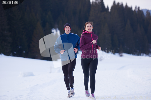 Image of couple jogging outside on snow